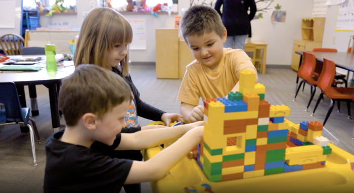 4K students playing with colorful block towers